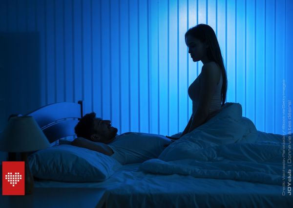 un homme et une femme dans une chambre à la lumière tamisée